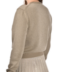 khaki cotton cardigan with a mandarin collar, mother-of-pearl buttons, and fine lurex jacquard detailing, styled with a matching lurex pleated skirt.